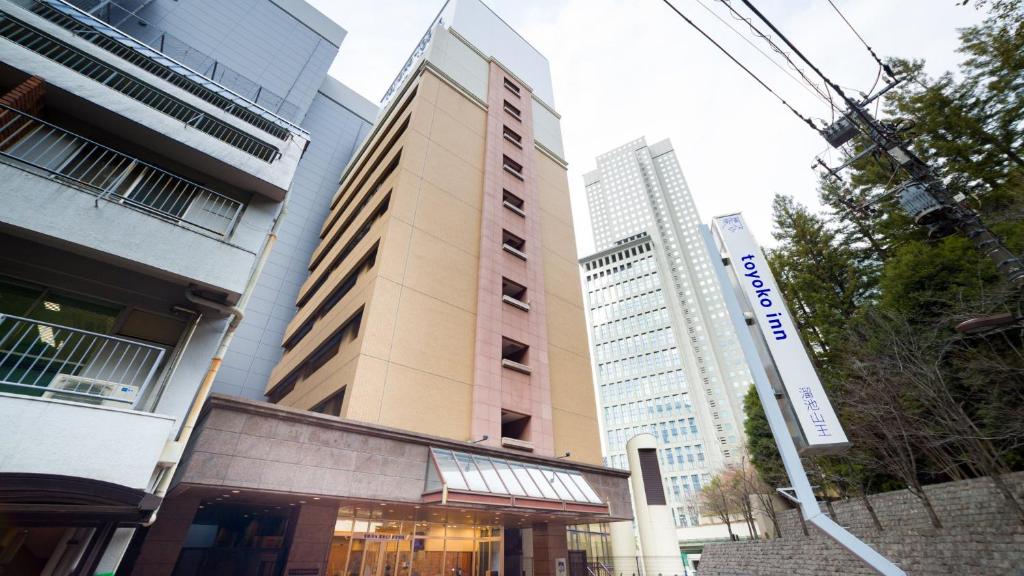 a building in a city with tall buildings at Toyoko Inn Tokyo Tameike-sanno-eki Kantei Minami in Tokyo