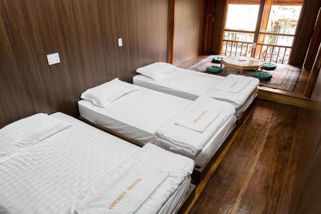 Postel nebo postele na pokoji v ubytování Odyssey Hostel, Tours & Motorbikes Rental
