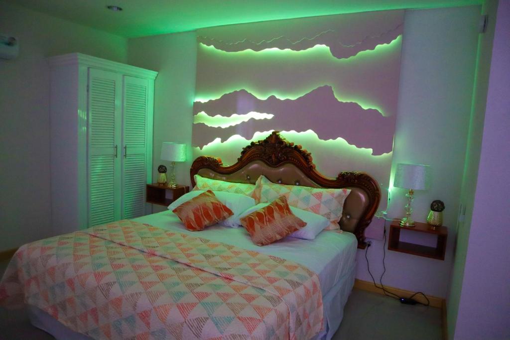 a bedroom with a bed with a cloud mural on the wall at Escappé Suites 