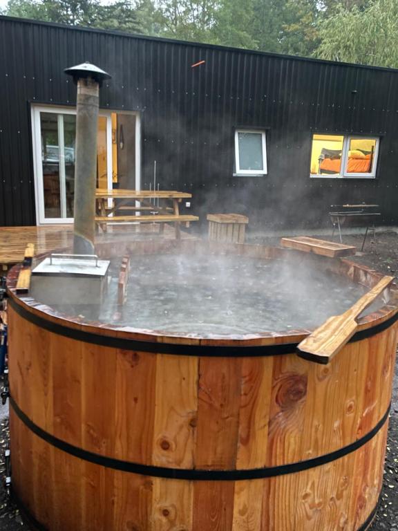 a hot tub in a wooden barrel with smoke coming out at Villarrica Pucón Aldea Molco in Villarrica