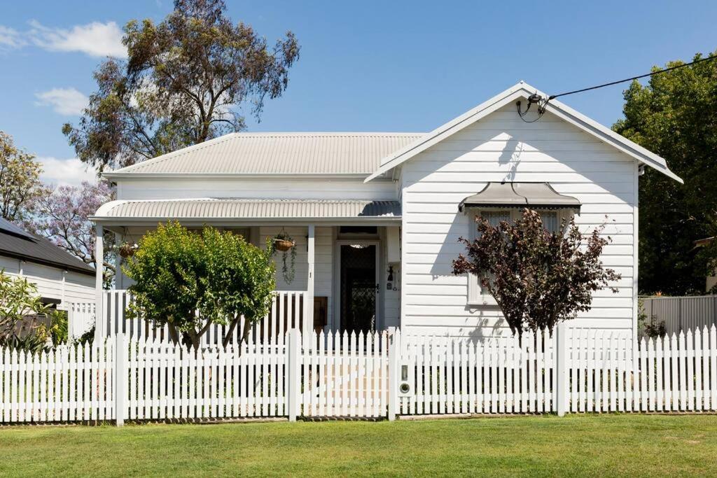 a white house with a white picket fence at The Hunter House c1917 in Cessnock