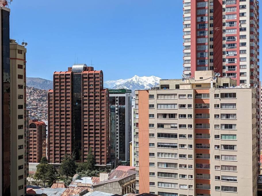 Blick auf eine Stadt mit hohen Gebäuden und Bergen in der Unterkunft Cómodo y céntrico mono ambiente in La Paz