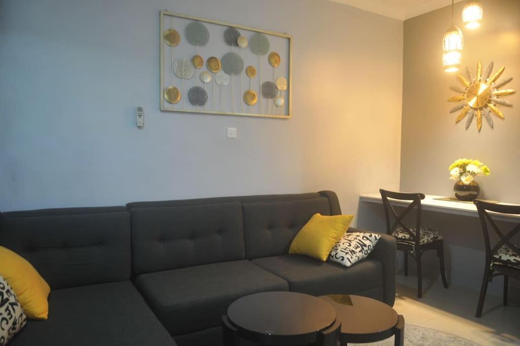 a living room with a couch and a table at Atlantic Court Apartment in Abuja