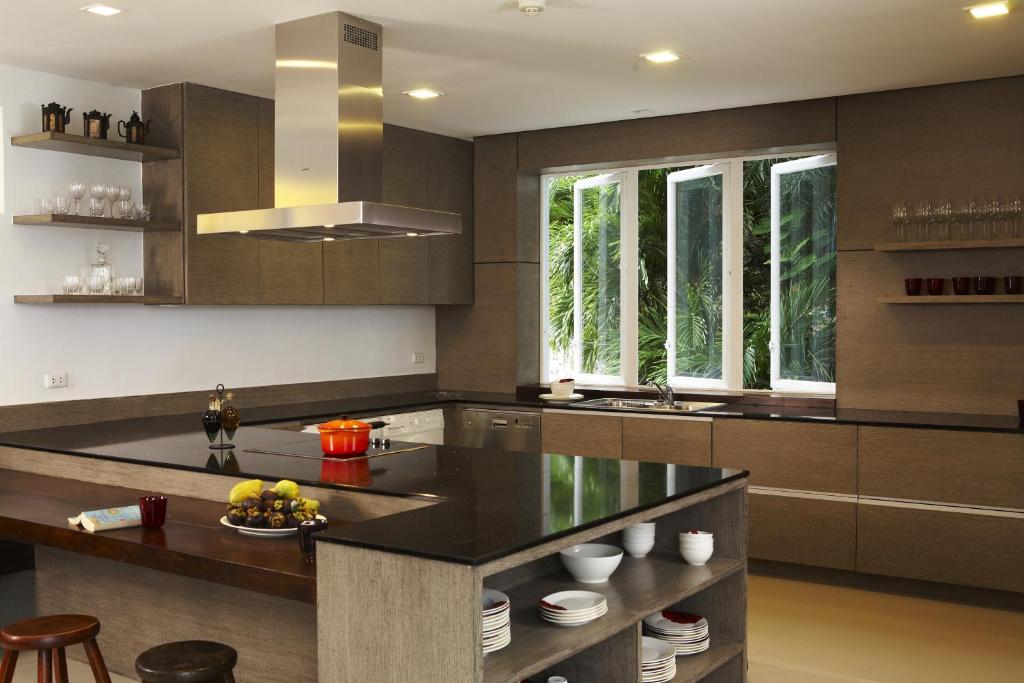 a kitchen with a black counter top and some windows at Jirana Patong in Patong Beach