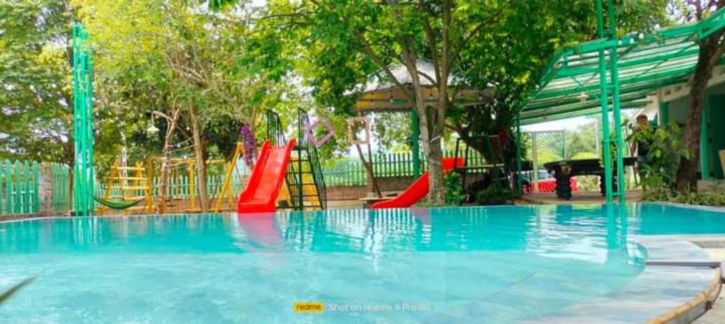 a swimming pool with a playground with a slide at Estrella Ba Vì Villas - Venuestay in Ba Vì