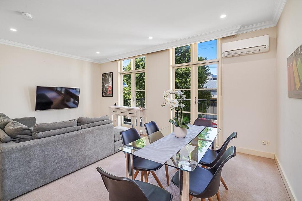 a living room with a table and chairs and a couch at Chelsea Terrace in Newcastle