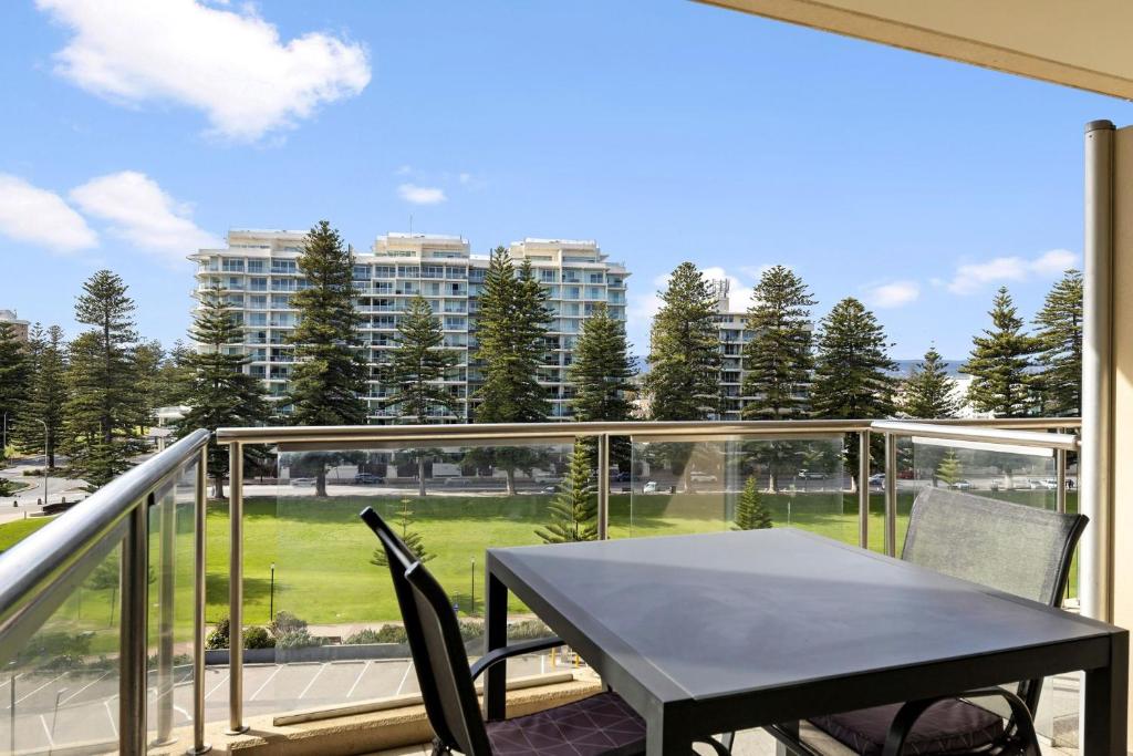 a black table and chairs on a balcony with a view at Belle Escapes - Seacrets at Glenelg in Glenelg