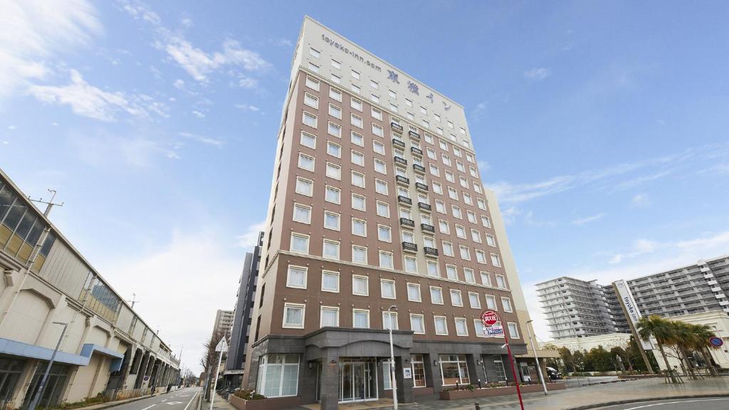a tall building on the corner of a street at Toyoko Inn Chiba minato Ekimae in Chiba