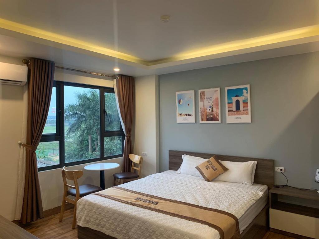 Postel nebo postele na pokoji v ubytování NEW SKY AIRPORT HOTEL NỘI BÀI
