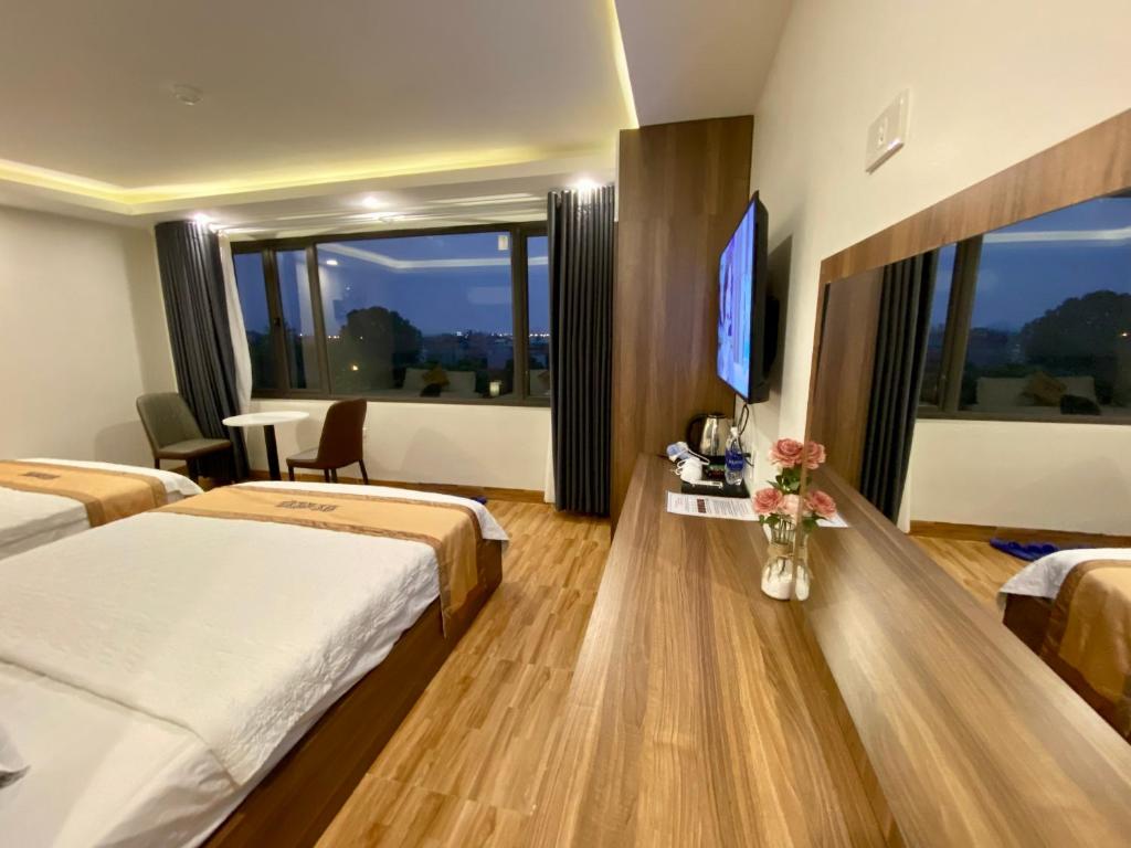 Postel nebo postele na pokoji v ubytování NEW SKY AIRPORT HOTEL NỘI BÀI