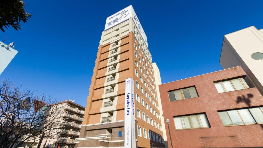 a tall building with a sign on top of it at Toyoko Inn Fujisan Numazu eki Kita guchi No 2 in Numazu