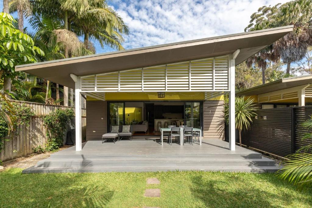 a house with a patio with a table and chairs at At Lizzie in Elizabeth Beach