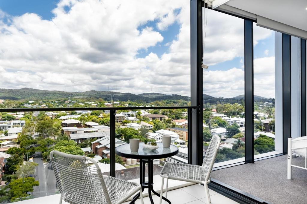 a view from the balcony of a house with a table and chairs at Brandnew Spacious and Stunning 1bed Apartment in Brisbane