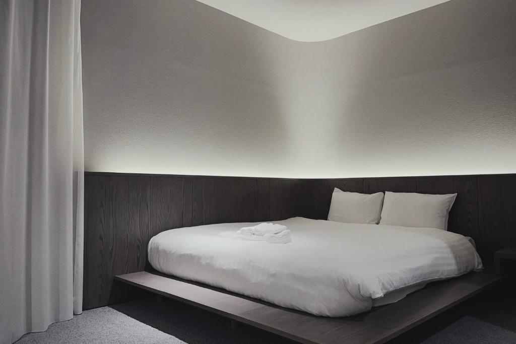 Postel nebo postele na pokoji v ubytování Hotel Rakuragu