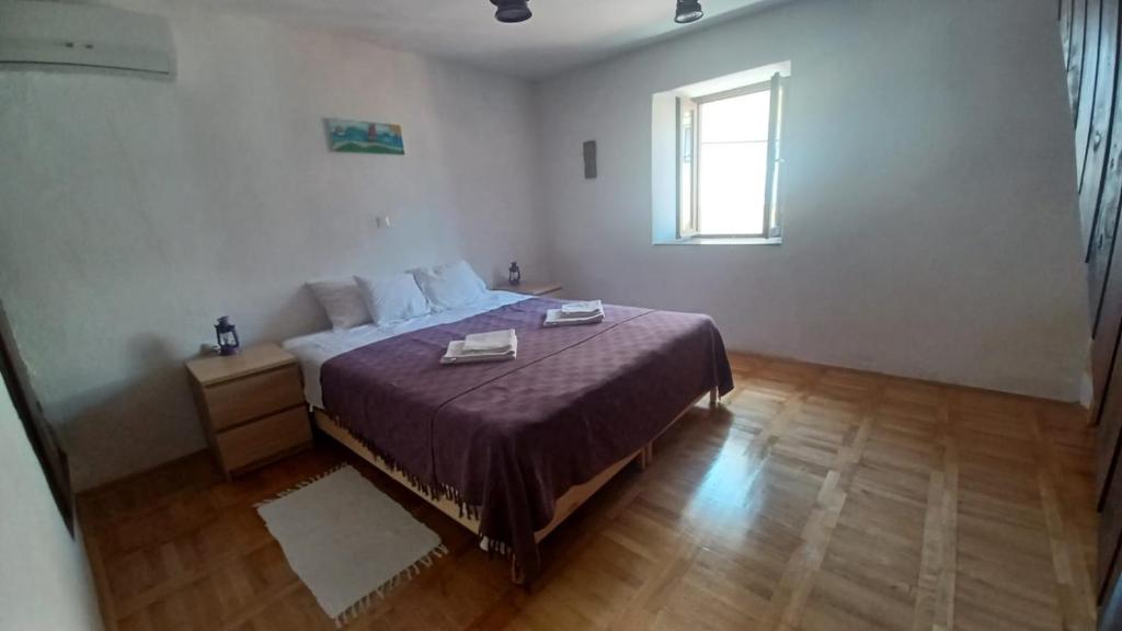 Postel nebo postele na pokoji v ubytování Apartmani Krapanj
