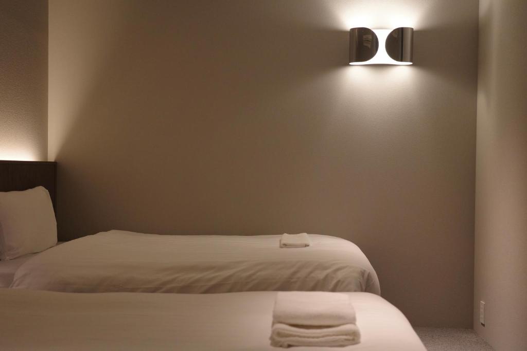 Postel nebo postele na pokoji v ubytování Hotel Rakuragu