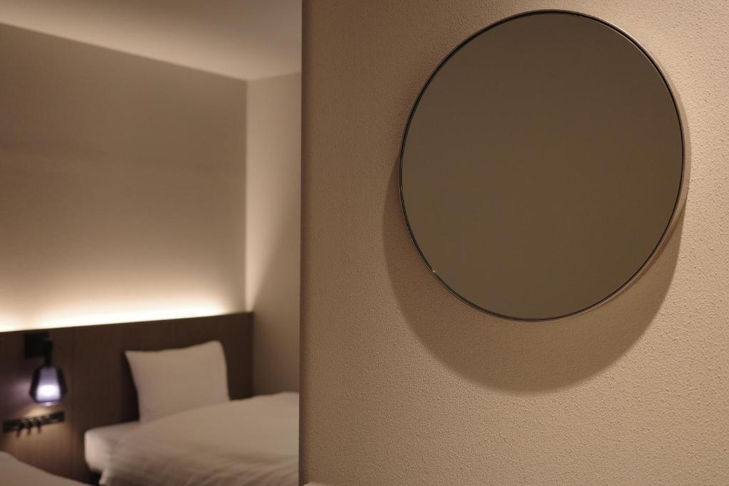 Postel nebo postele na pokoji v ubytování Hotel Rakuragu