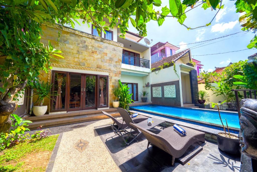 an image of a house with a swimming pool at Pondok DEWI Villa - LEGIAN - 6 Bedroom Villa - Great Location in Legian