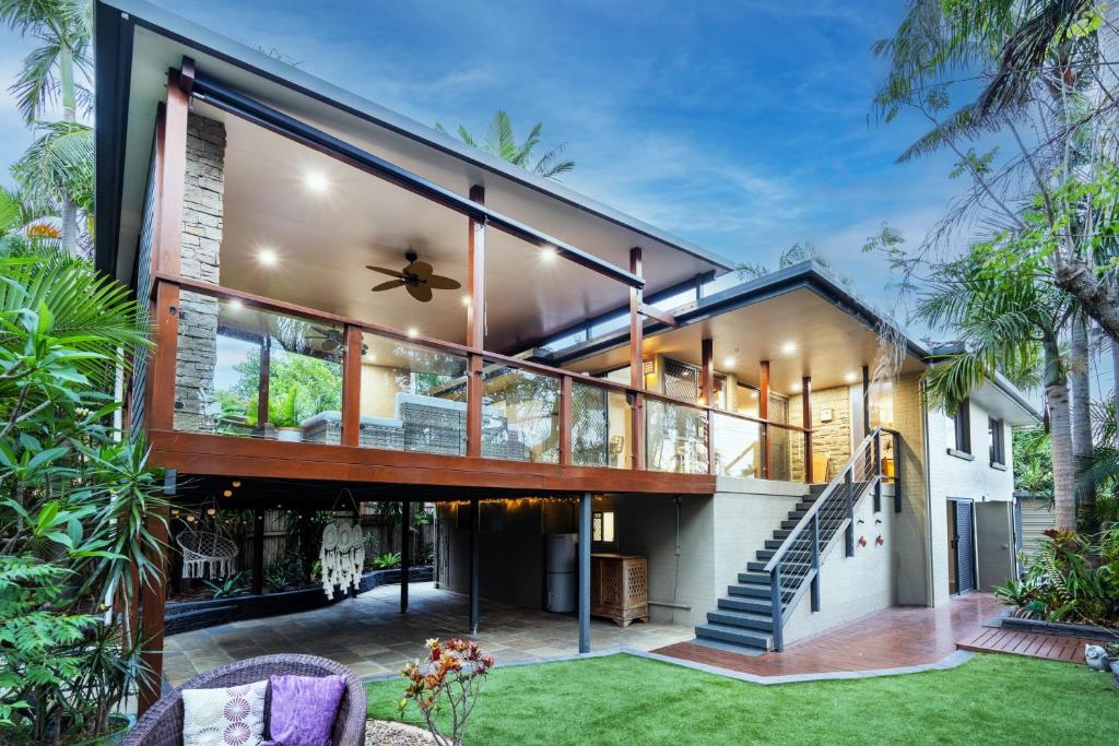 a house with a large glass facade at Bali Vibes Serene Tropical Oasis 4BD Holiday Home in Brisbane