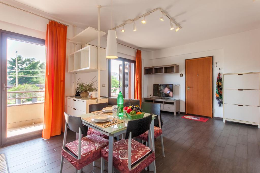 cocina y comedor con mesa y sillas en Vicerè Apartment With AC and Wi-Fi - Happy Rentals en Catania