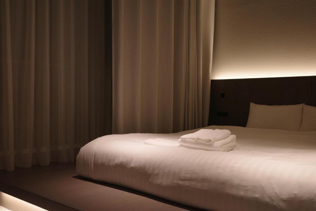 Postel nebo postele na pokoji v ubytování Hotel Rakuragu