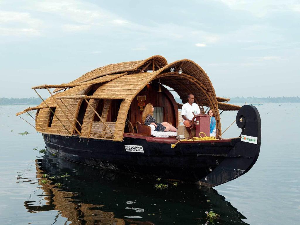 a group of people on a boat in the water at Soma House Boat in Alleppey