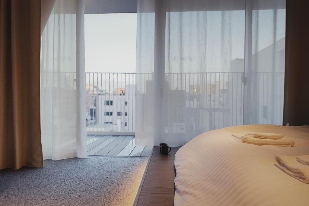 Postel nebo postele na pokoji v ubytování Hotel Rakuragu