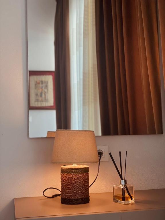 a lamp sitting on a table in a room at The Blue Horizon in Vlorë