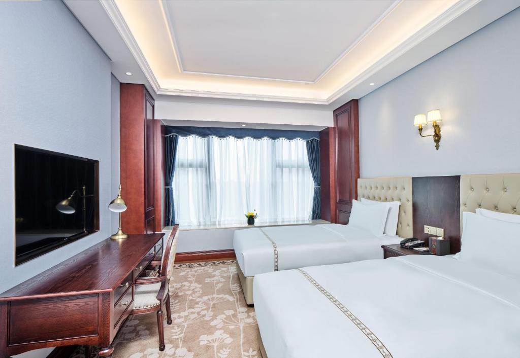 TV a/nebo společenská místnost v ubytování Guangming CIMC Executive Hotel Shenzhen