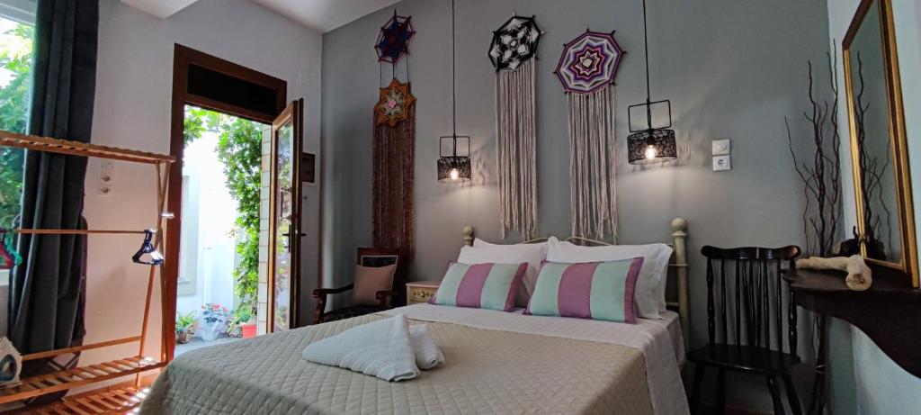 a bedroom with a bed with white sheets and pillows at Dream Catcher Studio in Skopelos Town