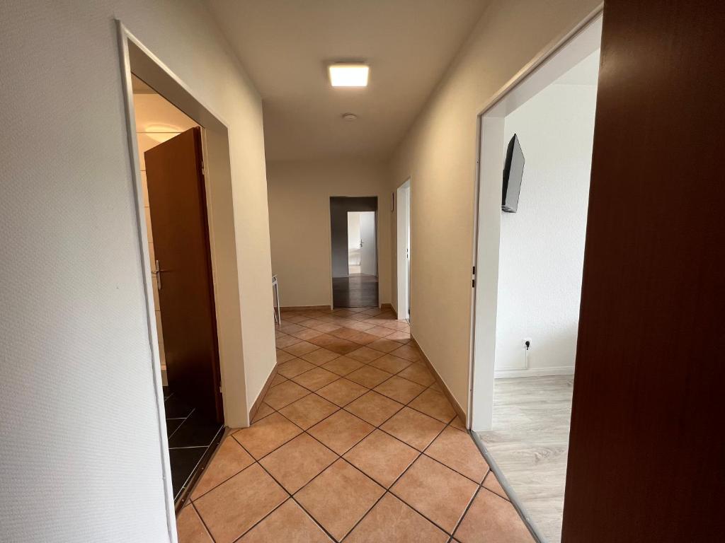 a hallway with a tile floor and a mirror at "Live Good, Work Good"- Central Apartment by GG Rental Hamburg in Hamburg