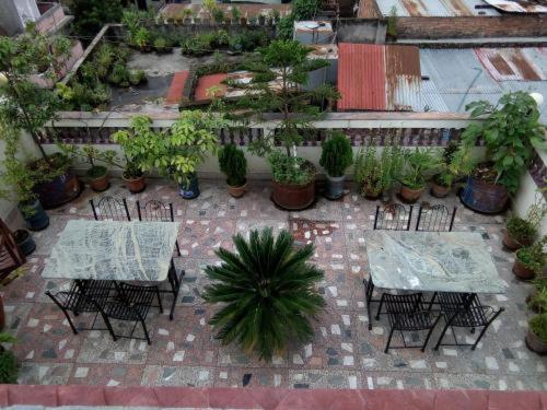 a patio with tables and chairs and potted plants at Hotel Sweet Dreams thamel kathmandu in Kathmandu