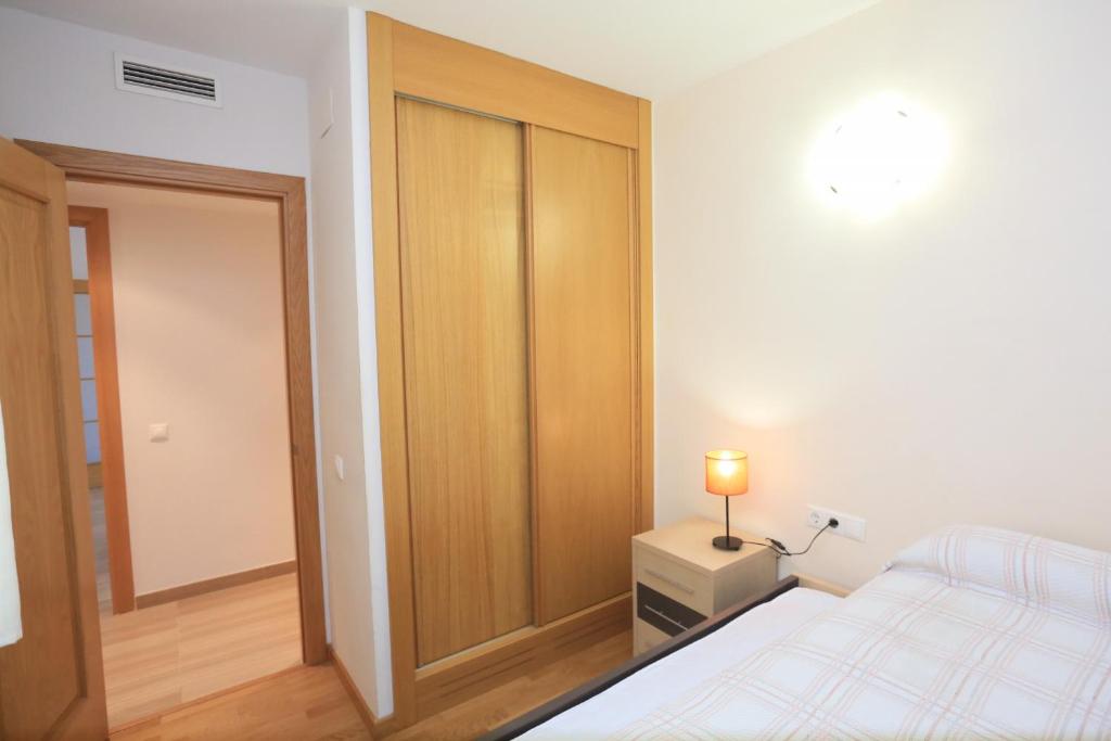 A bed or beds in a room at LITORAL COSTA DORADA - ESQUIROL Only families