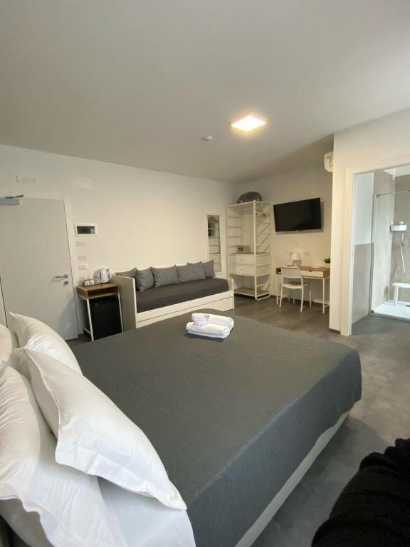 a bedroom with a large bed and a couch at Boutique Hotel Nuovo Cason in Cavallino-Treporti