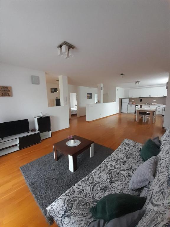 a living room with a couch and a table at Apartment Ken in Surčin