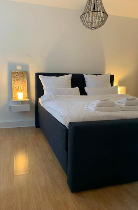 a bedroom with a large black bed with white pillows at Redlinburg II in Quedlinburg