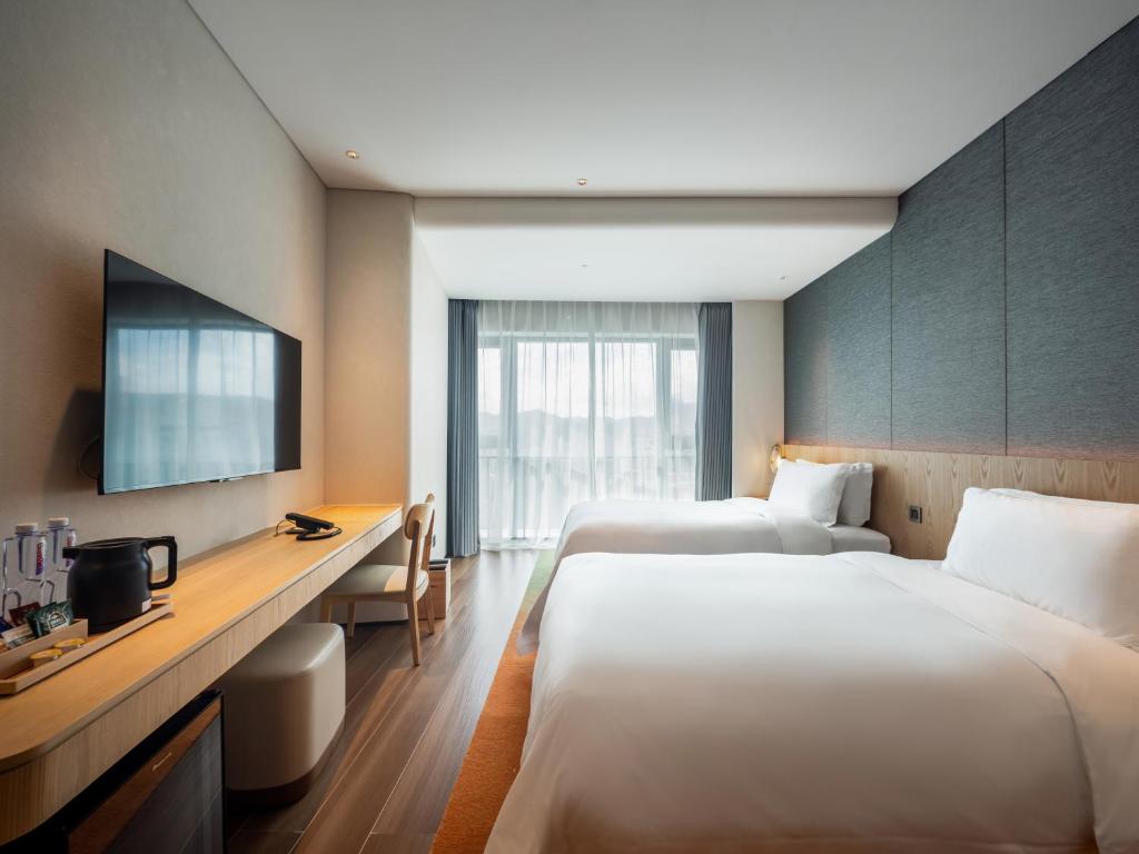 Postel nebo postele na pokoji v ubytování Jingju Hotel Shenzhen