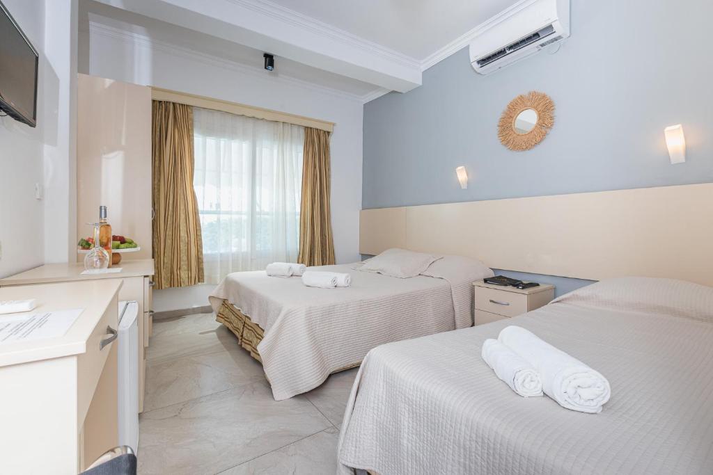 a hotel room with two beds and a window at AÇELYA OTEL in Bodrum City
