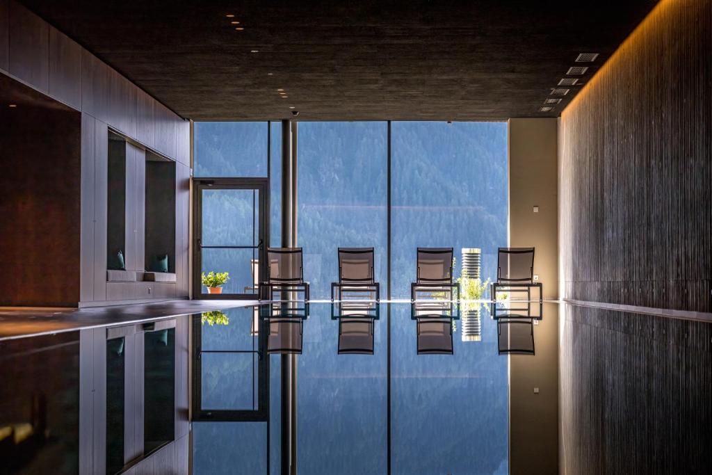 a group of chairs sitting in a pool of water at Mountain Residence Montana in Santa Maddalena