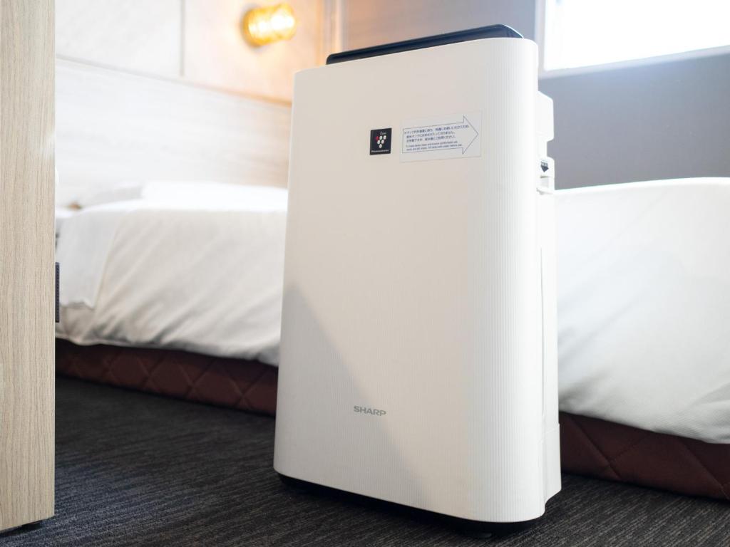 Postel nebo postele na pokoji v ubytování Super Hotel Tokyo Otsuka
