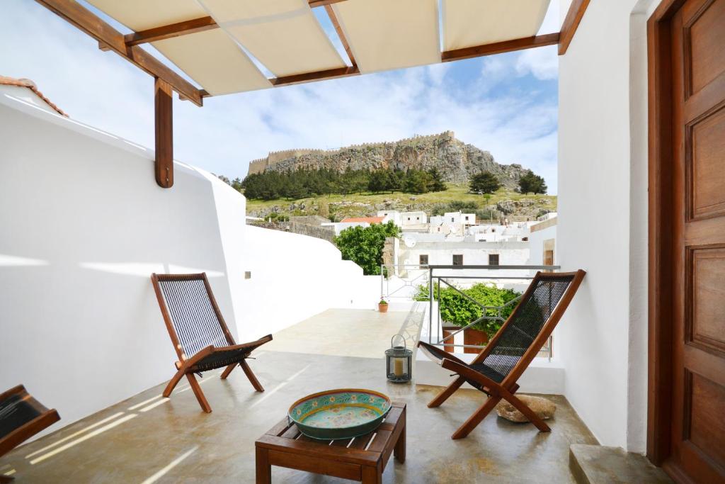 a view from the balcony of a house with two chairs at Casa Lindos in Lindos