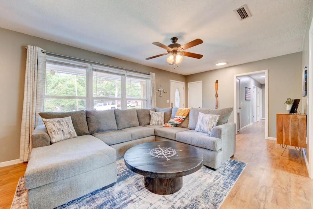 a living room with a couch and a ceiling fan at High-Flying Haven 4bd 2 bath in Enterprise