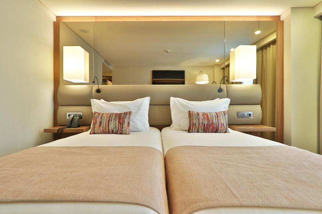 a bedroom with two beds in a room at TURIM Ibéria Hotel in Lisbon