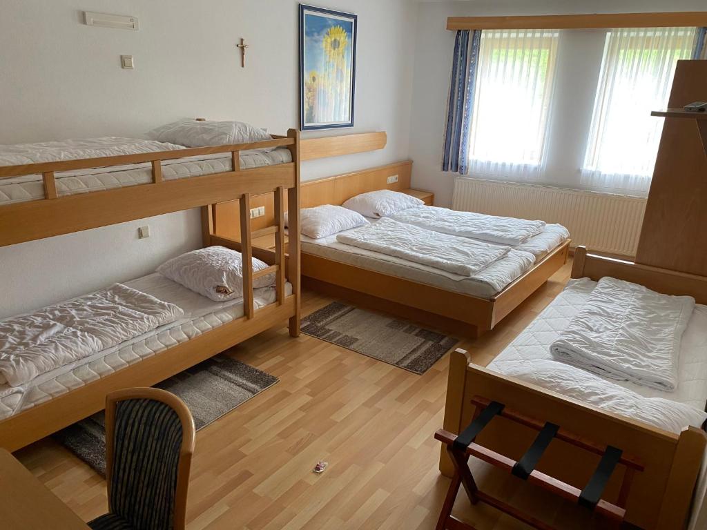 A bed or beds in a room at Waldschlössl Gasthof
