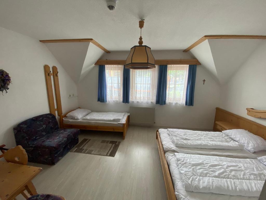 A bed or beds in a room at Waldschlössl Gasthof