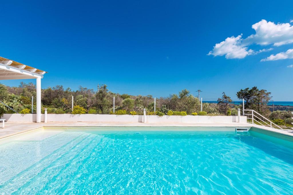 a swimming pool with a view of the ocean at Villa Amoenitas by Perle di Puglia in Ugento