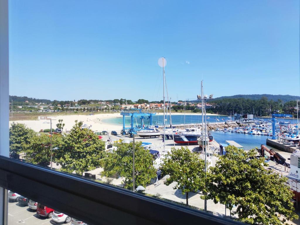 a view of a marina with boats in the water at Desconectaengalicia El Pescador, vistas al puerto, 200m playa in Portonovo