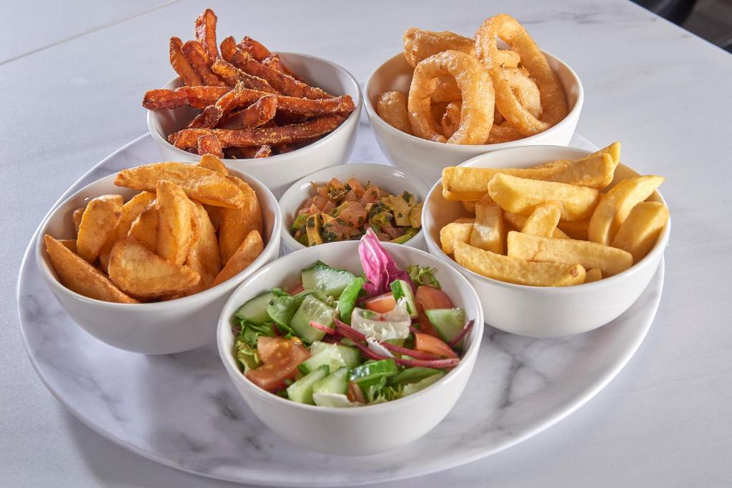 a plate with four bowls of food on a table at The Crown Hotel in Weymouth