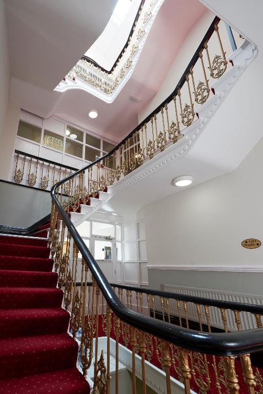 a set of stairs in a building with a skylight at The Crown Hotel in Weymouth