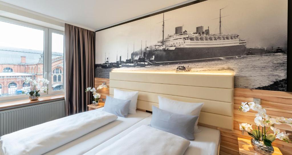 two beds in a room with a picture of a cruise ship at PLAZA Premium Columbus Bremen in Bremen